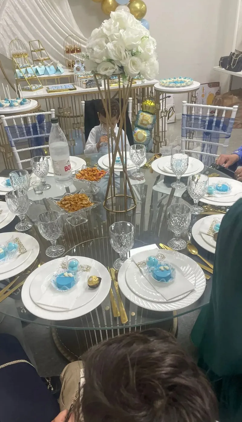 Mesa elegante con copas de cristal y centros florales para comunión en Sabadell